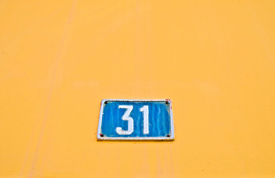 Number 31, thirty-one, blue on pale orange.