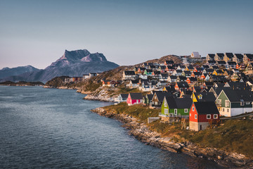 Nuuk capital of Greenland with Beautiful small colorful houses in myggedalen during Sunset Sunrise Midnight Sun. Sermitsiaq Mountain in Background. Blue and pink Sky. - obrazy, fototapety, plakaty