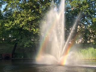 fountain in the park with rainbow