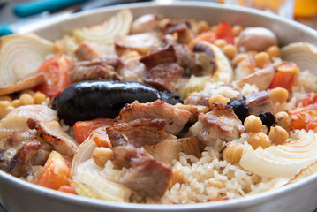 Detail of traditional Spanish dish, Mediterranean food, oven rice with sausage.