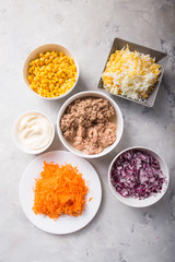 Ingredients for cooking salad with tuna and corn on a  concrete background. Tuna Salad Recipes. Top view, copy space.