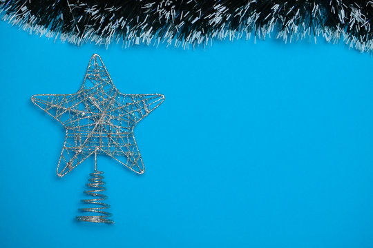 star of wire new year's decoration on blue background stock photo