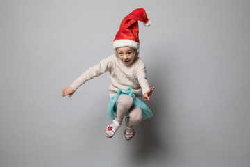 Smiling girl in the winter look on the grey