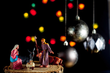 Christmas Manger scene with Jesus, Mary and Joseph with unfocused lights