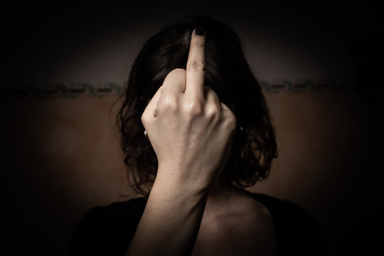Brunette woman showing middle finger