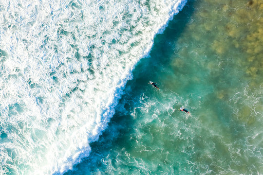 Aerial view of man surfing near Alexandria beach, Noosa, Australia.