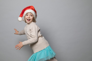 Smiling girl in the winter look on the grey