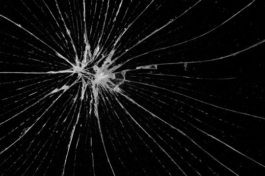 Abstract broken glass texture on a black background. Cracked black glass