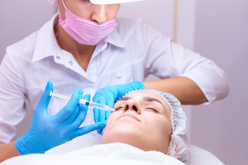 Young woman on rejuvenation procedure in a cosmetology clinic.