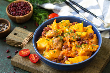 Thanksgiving Autumn Menu. Stew with beans and vegetables in a bowl on a rustic table.