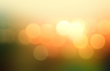 Bright lights and shde abstract illustration. Green yellow orange gradient blurred background. Golden bokeh pattern. Summer dawn sky and field natural decoration.