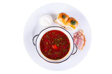 Red borsch with pieces of lard and garlic buns