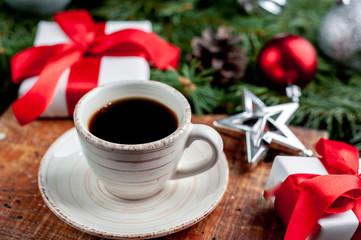 Christmas coffee and croissants with Christmas tree and gifts, toys on a stone background