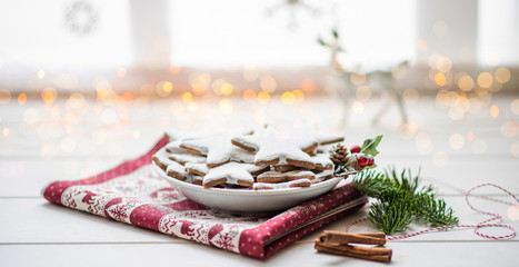 Vintage Christmas background. Christmas homemade gingerbread cookies on plate on white wooden table. Christmas, winter, new year concept. Copy space.