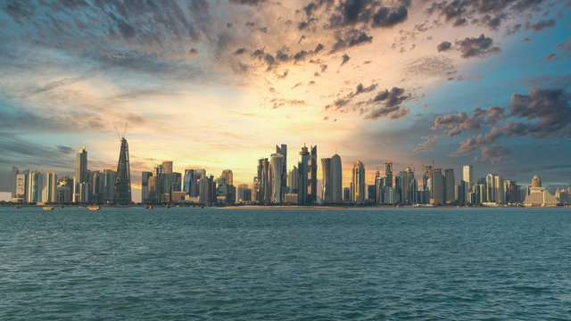 Doha Qatar skyline cityscape with skyscrapers under dramatic clouds