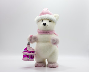 Christmas toy teddy bear with a gift on a white background