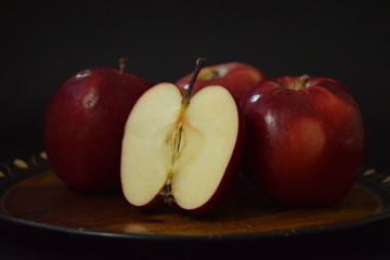 Red Apples Whole And Cut On Wooden Plate