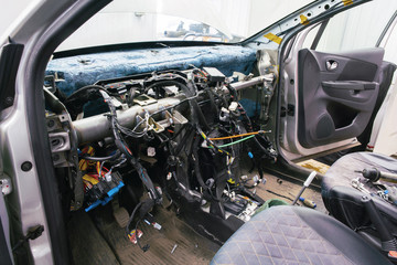 Disassembled interior of the car, without the front panel and protruding wires.