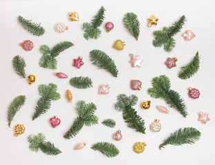 Christmas or New Year background: fir tree branches, glass balls, decoration and cones on a white background