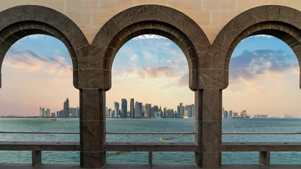 Fotobehang Doha skyline through as seen from Museum of Islamic art, Doha, Qatar © CanYalicn