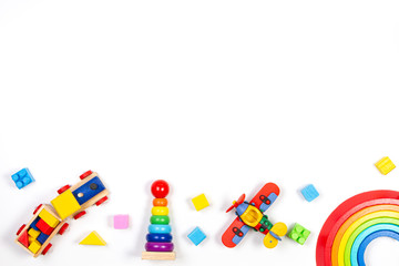 Baby kids toys background. Wooden train, rainbow stacker, red plane, stacking rings tower pyramid toy and colorful blocks. Top view, flat lay