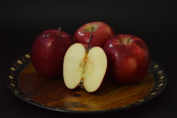 Red Apples Whole And Cut On Wooden Plate