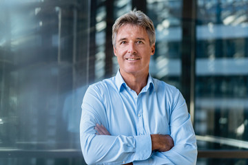 Portrait of confident mature businessman outside an office building