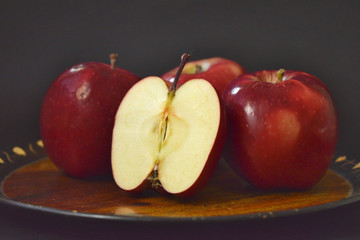 Red Apples Whole And Cut On Wooden Plate