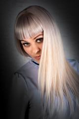 Naklejka premium Portrait of a beautiful woman with long blond hair. Shooting in the Studio.