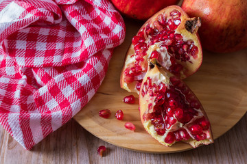 natural open pomegranate fruit on wood