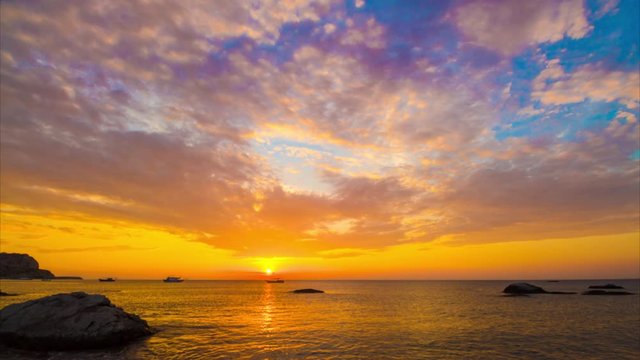 Beach sunrise over the sea horizon, Rhodes island, Greece. Fast rising sun. Timelapse.