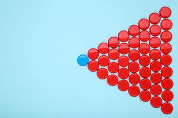 Bottle caps leader on blue background