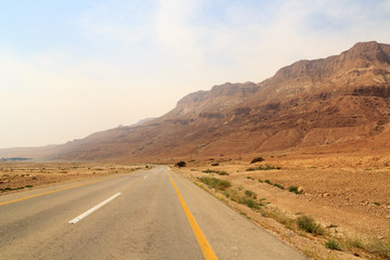 Street highway 90 and Judaean Desert panorama with natural terraces at mountains in West Bank,...
