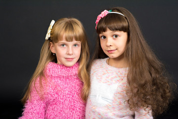 Shooting in the Studio, two girls stand together