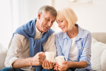 Love lives forever! Loving senior couple drinking tea