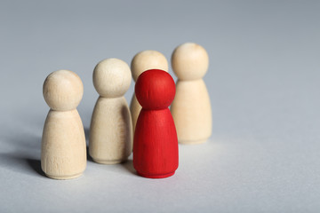 Leader concept. Wooden figures on grey background