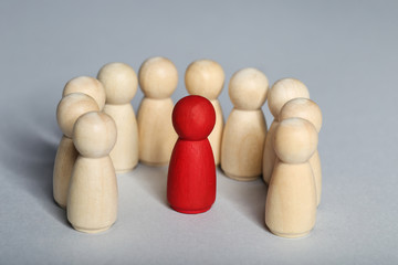 Leader concept. Wooden figures on grey background