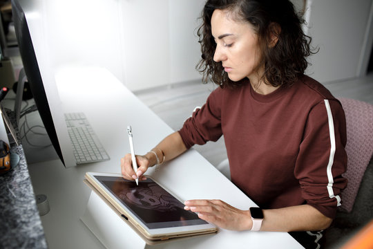 Female web designer using tablet at home