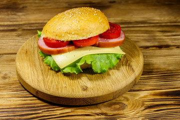 Fresh delicious homemade cheeseburger on wooden table