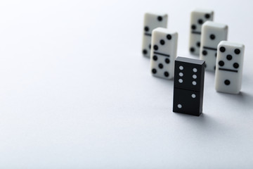 Leader concept. Domino tiles on grey background