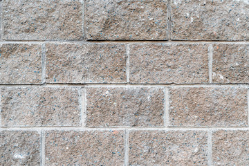 The texture of the massive wall of large gray stone. The basement of a large building.
