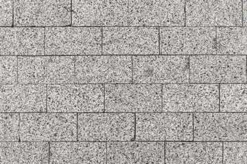 Texture of gray road granite tiles. Stone pavement background.