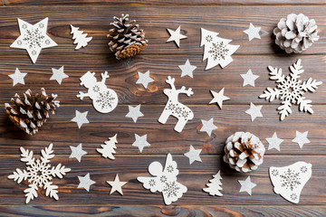 Top view of Christmas toys on wooden background. New Year ornament. Holiday concept.