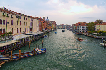 Obraz premium Scenic morning view of the Grand Canal with ancient colorful buildings and different ships are sailing along the canal. Famous touristic place and travel destination in Europe. Venice, Italy