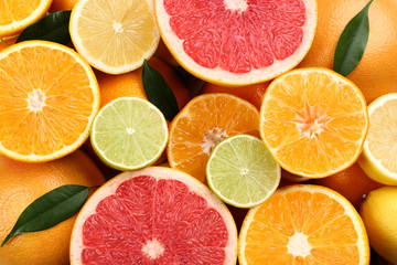 Tangerines and different citrus fruits as background, top view