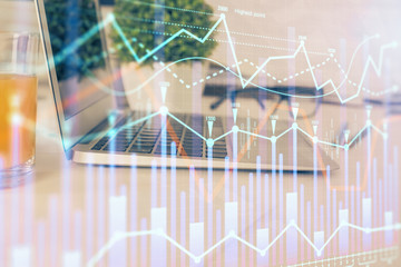 Forex Chart hologram on table with computer background. Multi exposure. Concept of financial markets.