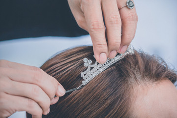 bride dress wear a crown on her head is a picture taken at the wedding.