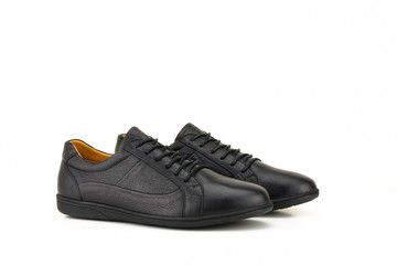 Black leather sneakers isolated on white background.
