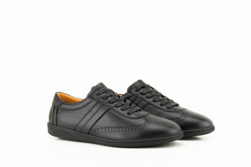 Black leather sneakers isolated on white background.