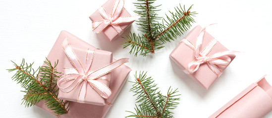Christmas pink flat lay. Holiday boxes, fir branches on white background. Christmas winter holiday congratulation invitation birthday wedding.Long banner